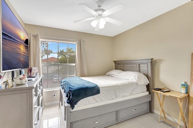bedroom featuring a ceiling fan, baseboards, and light tile patterned flooring