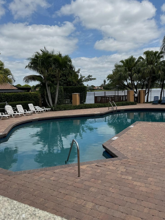 pool featuring a patio area and fence