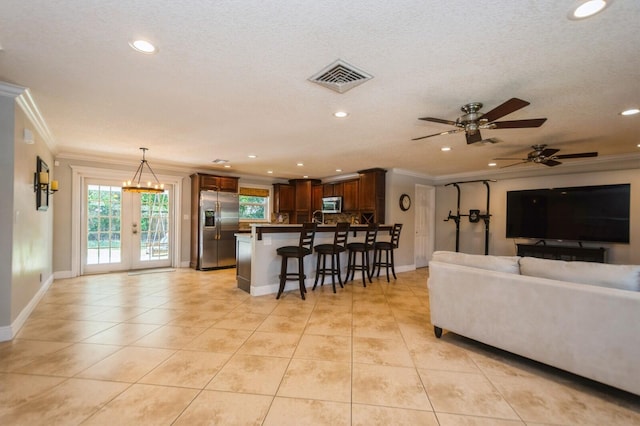 living area featuring recessed lighting, visible vents, ornamental molding, light tile patterned floors, and ceiling fan