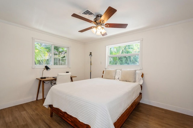 bedroom featuring wood finished floors, baseboards, and ornamental molding