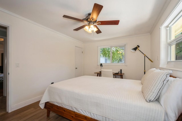 bedroom featuring a ceiling fan, baseboards, multiple windows, and wood finished floors