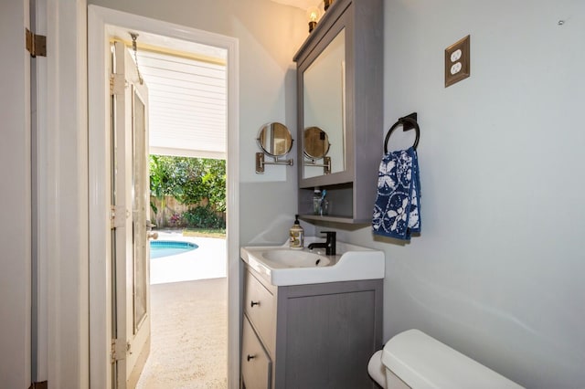 bathroom featuring toilet and vanity