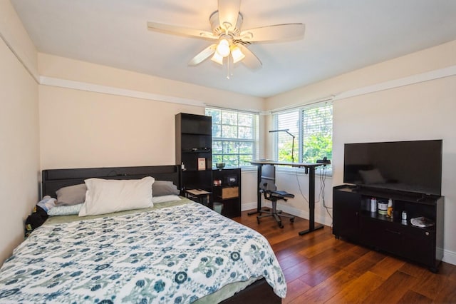 bedroom featuring a ceiling fan, baseboards, and dark wood-style flooring