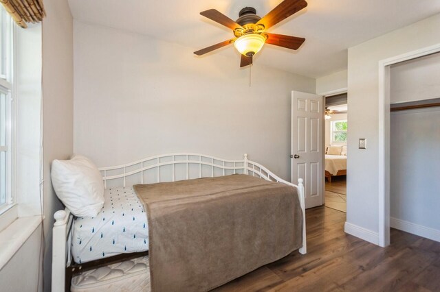 bedroom featuring baseboards, a ceiling fan, and wood finished floors