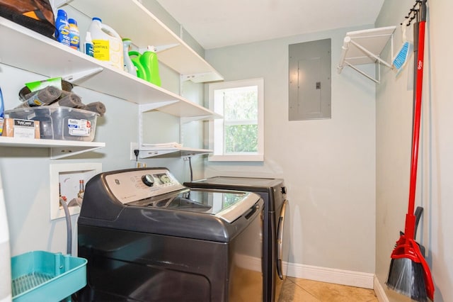 clothes washing area with electric panel, washer and clothes dryer, baseboards, tile patterned flooring, and laundry area