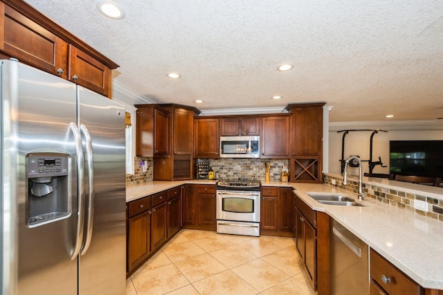 kitchen featuring ornamental molding, a sink, light tile patterned flooring, tasteful backsplash, and appliances with stainless steel finishes
