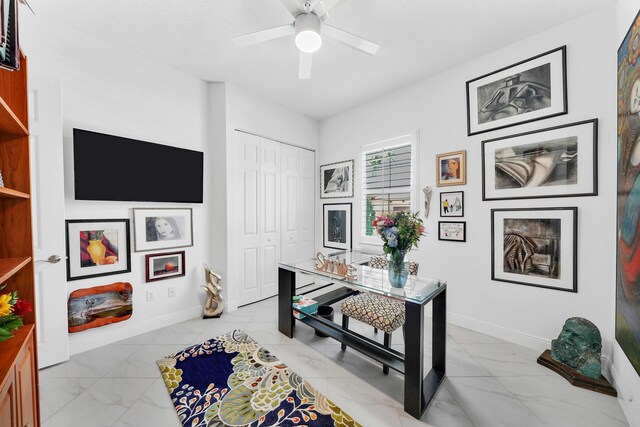 7816 Butera, Delray Beach, FL 33446 - office space featuring light marble finish flooring, a ceiling fan, and baseboards