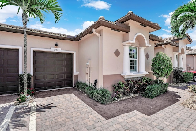 7816 Butera, Delray Beach, FL 33446 - mediterranean / spanish-style home with stucco siding, a garage, decorative driveway, and a tiled roof