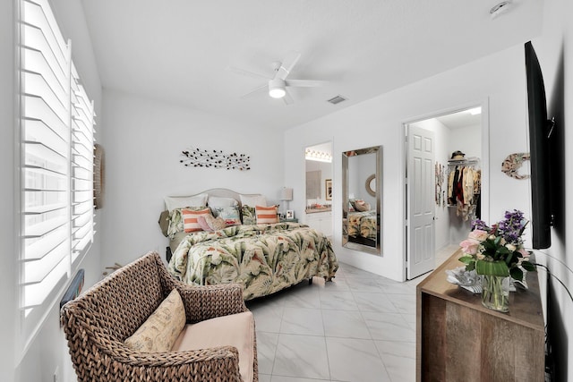 7816 Butera, Delray Beach, FL 33446 - bedroom featuring light marble finish floors, a spacious closet, ensuite bath, and a ceiling fan