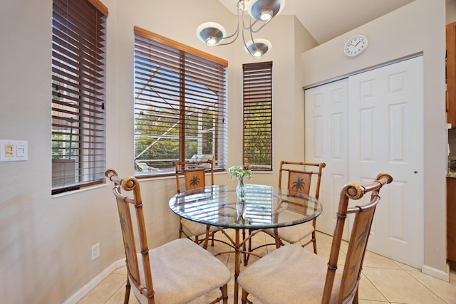 dining area featuring light tile patterned floors and baseboards