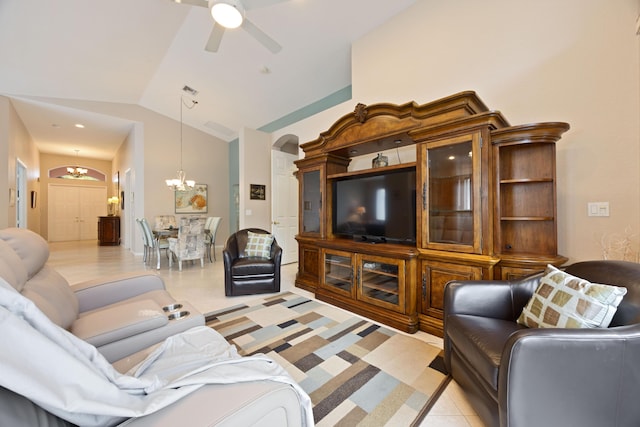 living area featuring arched walkways, ceiling fan with notable chandelier, and vaulted ceiling