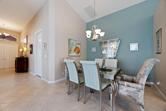 dining area with light tile patterned floors, an inviting chandelier, high vaulted ceiling, and baseboards