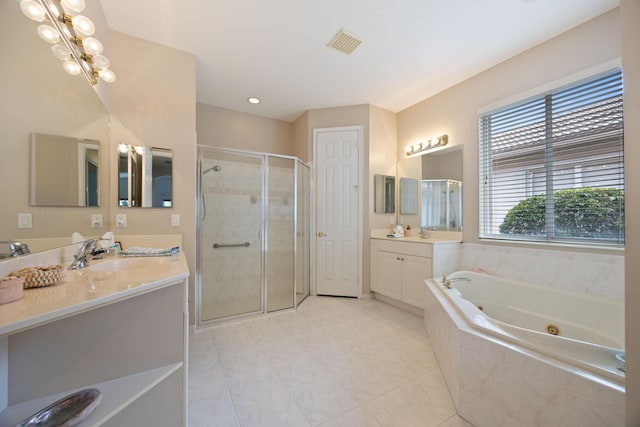 full bathroom featuring two vanities, a sink, visible vents, a stall shower, and a jetted tub