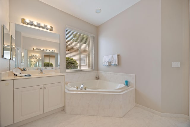 bathroom featuring vanity and a bath