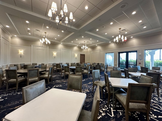 8926 Agliana Cir, Boynton Beach, FL 33472 - carpeted dining space featuring crown molding, a chandelier, and a decorative wall