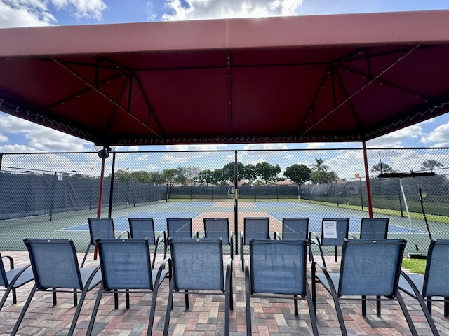 8926 Agliana Cir, Boynton Beach, FL 33472 - view of patio / terrace featuring outdoor dining space, fence, and a tennis court