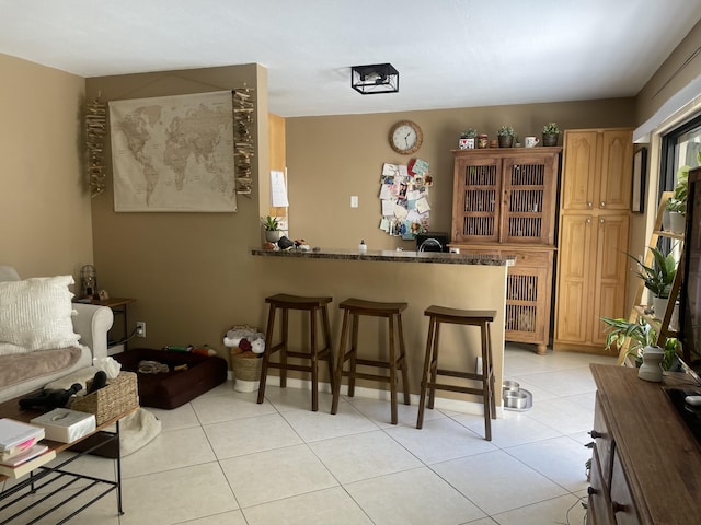unfurnished room with baseboards and light tile patterned floors