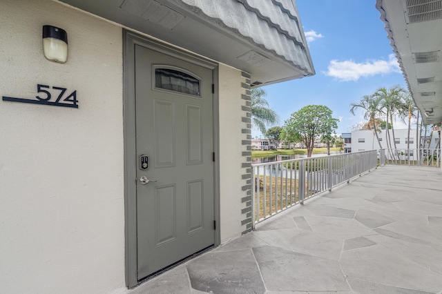 574 Monaco L, Delray Beach, FL 33446 - property entrance featuring stucco siding and a water view