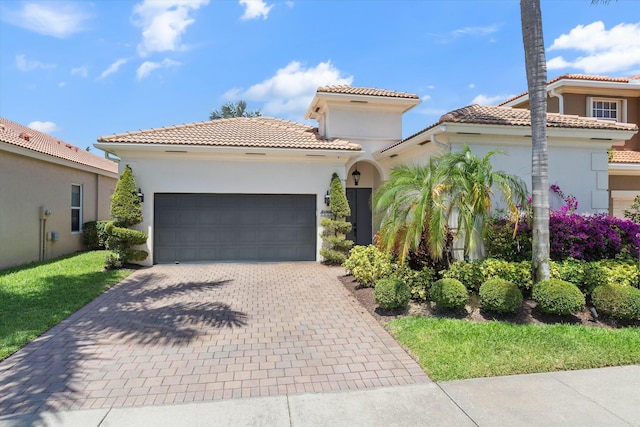 5828 Via De La Plata Cir, Delray Beach, FL 33484 - mediterranean / spanish-style home featuring decorative driveway, an attached garage, a tile roof, and stucco siding