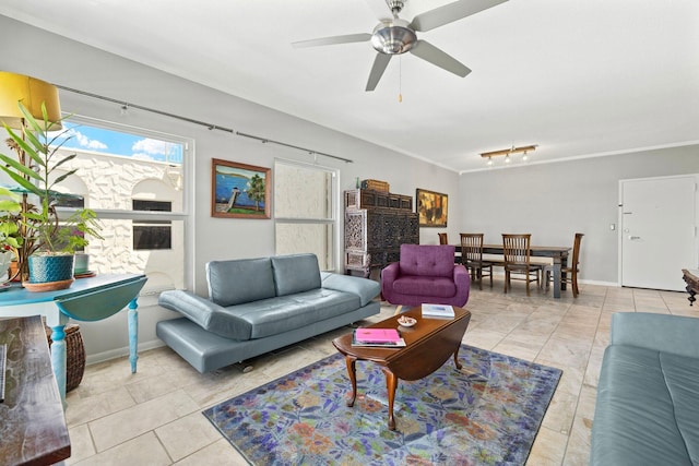 tiled living room with ceiling fan and crown molding