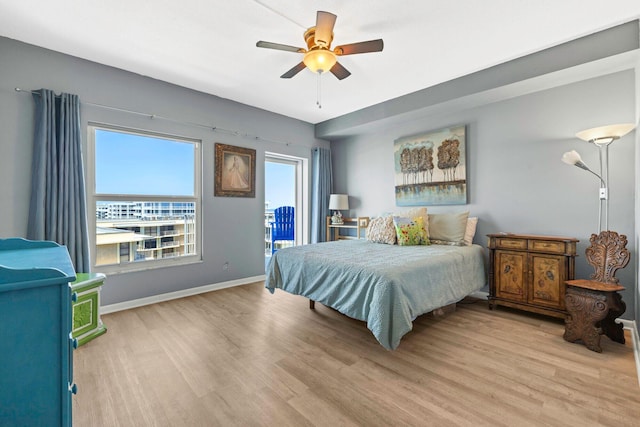 bedroom featuring light wood-type flooring, a ceiling fan, access to exterior, and baseboards