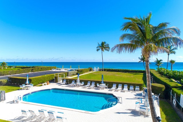pool with a water view and a patio area