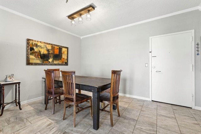 dining area featuring ornamental molding, a textured ceiling, and baseboards