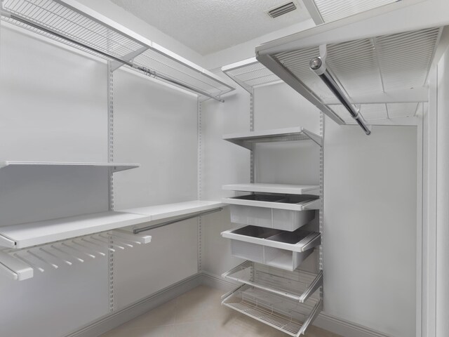 full bathroom featuring a shower stall, visible vents, a sink, and double vanity