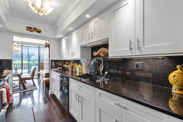 kitchen with white cabinets, dishwasher, a sink, crown molding, and a notable chandelier