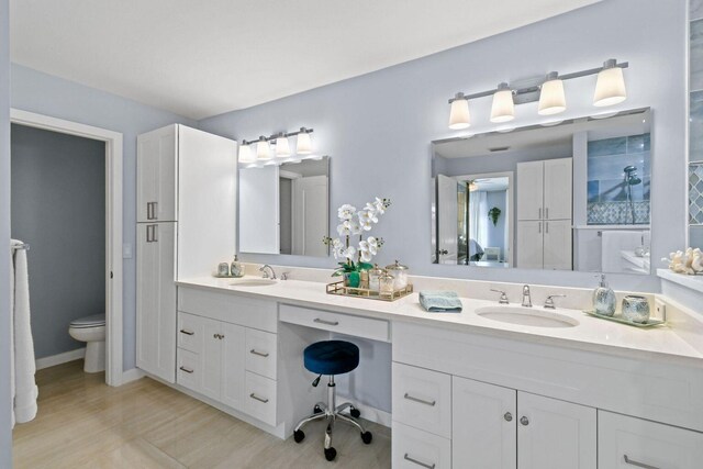 252 Legendary Cir, Palm Beach Gardens, FL 33418 - bathroom featuring double vanity, toilet, and a sink