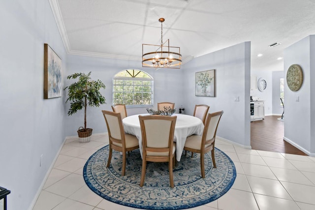 252 Legendary Cir, Palm Beach Gardens, FL 33418 - dining space with a chandelier, tile patterned floors, baseboards, and ornamental molding