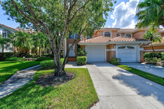 252 Legendary Cir, Palm Beach Gardens, FL 33418 - mediterranean / spanish-style home with a front lawn, a tiled roof, driveway, a garage, and stucco siding