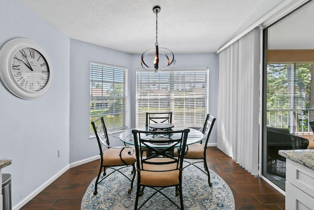 252 Legendary Cir, Palm Beach Gardens, FL 33418 - dining area featuring plenty of natural light, a textured ceiling, baseboards, and an inviting chandelier