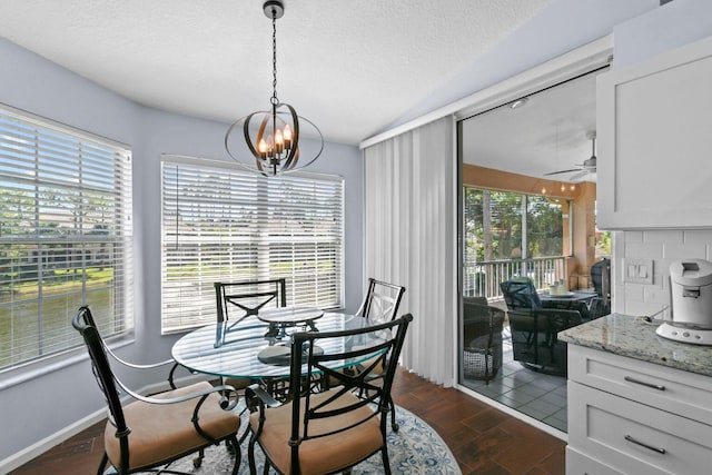 252 Legendary Cir, Palm Beach Gardens, FL 33418 - dining room with a wealth of natural light, a textured ceiling, dark wood-style floors, and ceiling fan with notable chandelier