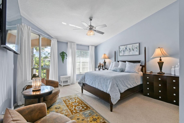 252 Legendary Cir, Palm Beach Gardens, FL 33418 - bedroom featuring a textured ceiling, access to exterior, vaulted ceiling, carpet, and ceiling fan