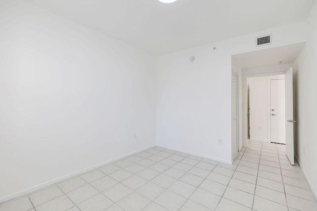 unfurnished room with visible vents, baseboards, and light tile patterned floors