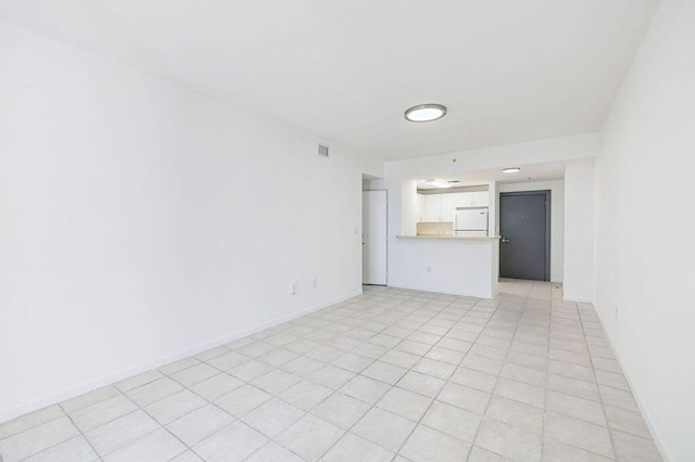 unfurnished living room featuring baseboards and visible vents