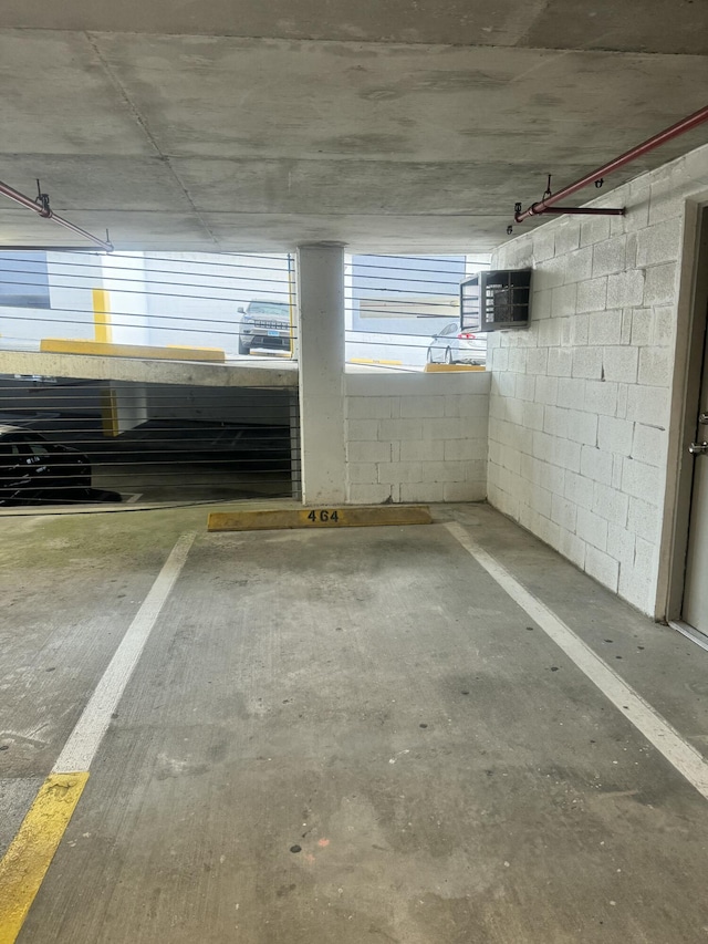 parking garage featuring concrete block wall