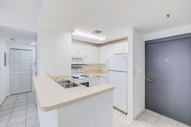 kitchen with a sink, white appliances, light countertops, a peninsula, and visible vents