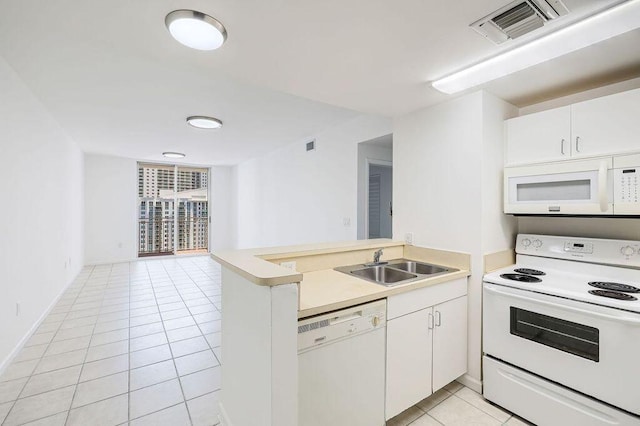 kitchen featuring a sink, light tile patterned flooring, white appliances, a peninsula, and visible vents