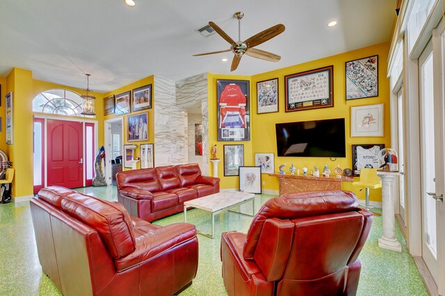 living area featuring recessed lighting, ceiling fan, baseboards, visible vents, and ornate columns