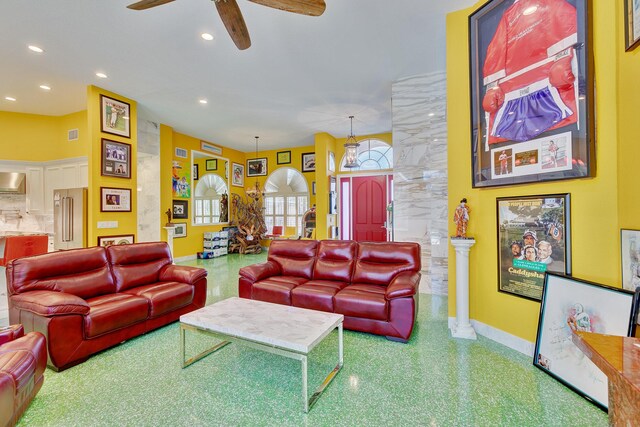 living room with ceiling fan, baseboards, and recessed lighting