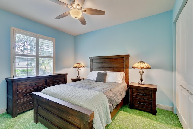 bedroom with light carpet, a ceiling fan, and baseboards
