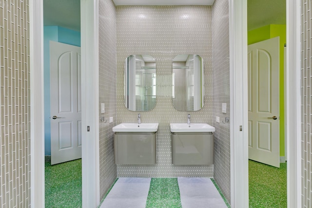 bathroom with tile walls and a sink