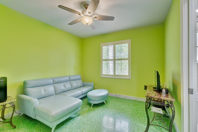 sitting room featuring ceiling fan, baseboards, and carpet flooring