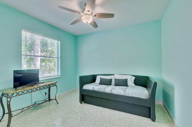 living area with carpet floors, baseboards, and ceiling fan