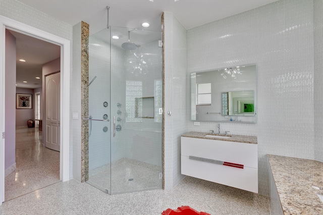 full bathroom featuring speckled floor, vanity, a stall shower, and recessed lighting