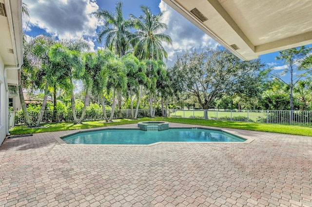 view of pool with a fenced backyard, a patio area, and a pool with connected hot tub