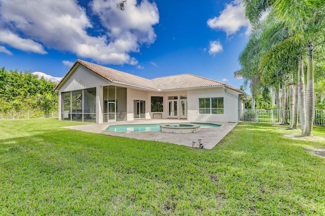 back of property with a tile roof, a sunroom, stucco siding, and fence