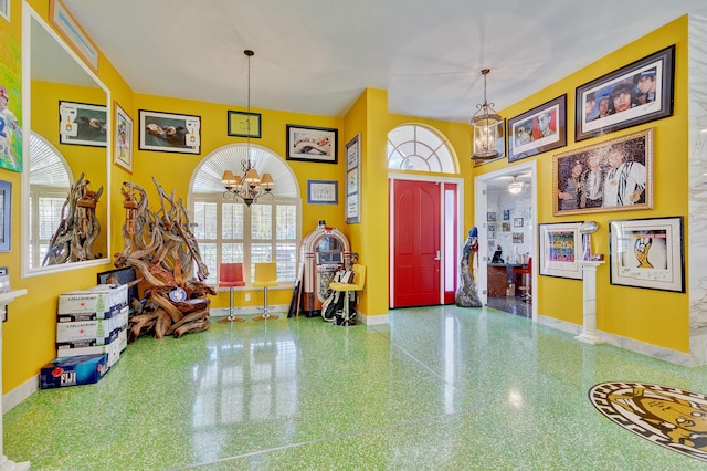 entryway with baseboards and an inviting chandelier